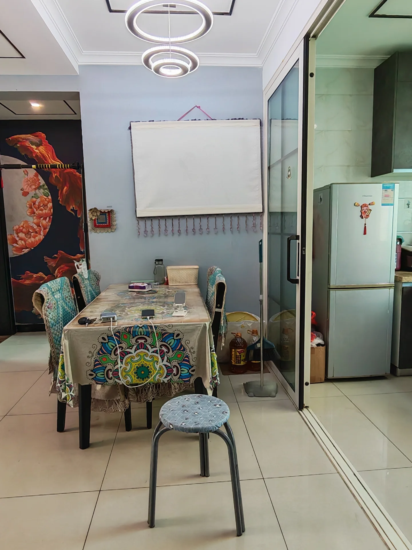 厨房区域，配备了不锈钢台面和大型冰箱，整体装修风格偏向实用功能型，光线充足。